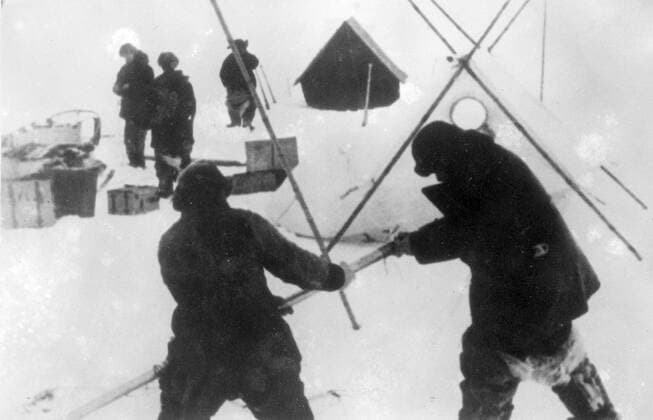 New pictures of Soviet scientist on ice floe, expedition rescued after drifting in Polar Seas. These pictures, just received in London, show the Soviet polar expedition on the North pole ice floe, in which they lived for nine months. Rescue expeditions succeeded in reaching the scientists as the ice crumbled beneath them and they are now on their way home. The expedition consisted of Ivan Papanin, (leader), Ernest Krenkel, radio operator, Pyotr Shirshov and Eugene Federov. Photo shows, members of the expedition erecting a tent on the ice floe. 3 March 1938, Arctic Copyright: Topfoto  UnitedArchivesEU052786