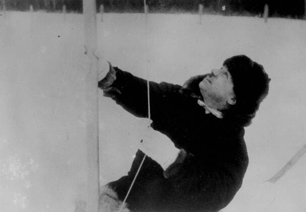 New pictures of Soviet scientist on ice floe, expedition rescued after drifting in Polar Seas. These pictures, just received in London, show the Soviet polar expedition on the North pole ice floe, in which they lived for nine months. Rescue expeditions succeeded in reaching the scientists as the ice crumbled beneath them and they are now on their way home. The expedition consisted of Ivan Papanin, (leader), Ernest Krenkel, radio operator, Pyotr Shirshov and Eugene Federov. Photo shows,Ivan Papanin, leader of the expedition, wasting the Soviet flag when he claimed the North Pole in the name of Soviet Russia. 3 March 1938, Arctic Copyright: Topfoto  UnitedArchivesEU053706