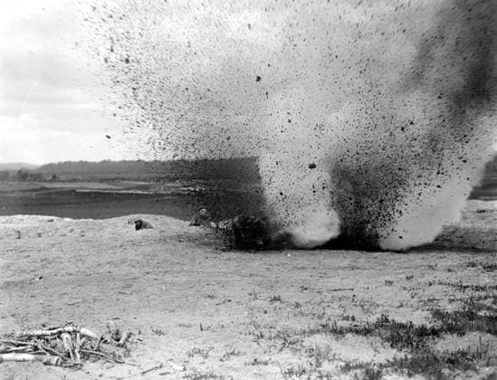 Training dogs at the War Dog s Training School at Lyndhurst. Dog jumps past explosion 26 April 1919, Lyndhurst Hampshire United Kingdom England Copyright: Topfoto  UnitedArchivesEU057047