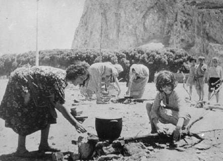 Spanish refugees seek safety at Gibraltar . These pictures , just received in London , were made at a special camp established at Gibraltar for the refugees who sought safety at the Rock from the terrors of the Spanish civil war . Hundreds of Spanish and other fugitives including many women and children , fled across the border into Gibraltar . Photo shows: Spanish refugees preparing food at the Gibraltar camp . 29 July 1936, Gibraltar Spain Copyright: Topfoto  UnitedArchivesEUFD000394