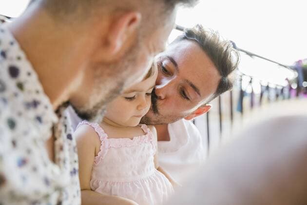 Affectionate gay couple with daughter on balcony model released Symbolfoto property released  MRAF00247