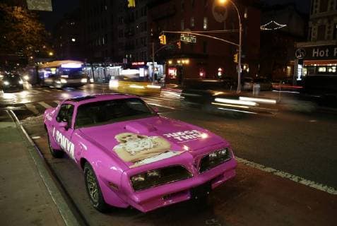 A pink classic car with the I Tonya movie logo and the image of Margot Robbie is parked on the street in in front of the theater before the I, Tonya New York Premiere at Village East Cinema on November 28, 2017 in New York City.  NYP20171128137 JOHNxANGELILLO