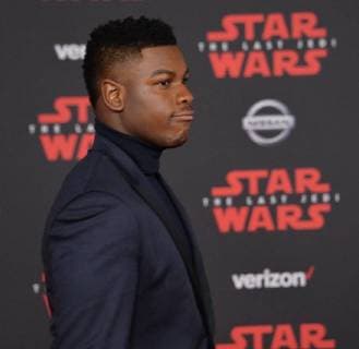 Cast member John Boyega attends the premiere of the sci-fi motion picture fantasy Star Wars: The Last Jedi at the Shrine Auditorium in Los Angeles on December 9, 2017. Storyline: Having taken her first steps into the Jedi world, Rey joins Luke Skywalker on an adventure with Leia, Finn and Poe that unlocks mysteries of the Force and secrets of the past.  LAP20171209202 JIMxRUYMEN