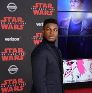 Cast member John Boyega attends the premiere of the sci-fi motion picture fantasy Star Wars: The Last Jedi at the Shrine Auditorium in Los Angeles on December 9, 2017. Storyline: Having taken her first steps into the Jedi world, Rey joins Luke Skywalker on an adventure with Leia, Finn and Poe that unlocks mysteries of the Force and secrets of the past.  LAP20171209200 JIMxRUYMEN