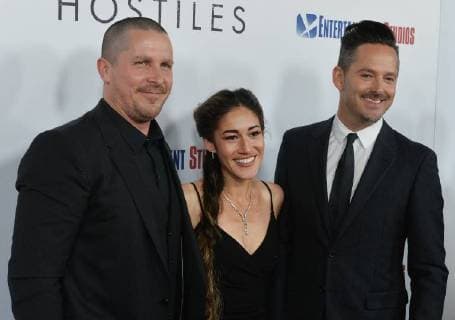 Cast members Christian Bale and Q orianka Kilcher join director Scott Cooper (R) on the red carpet during the premiere of the motion picture western Hostiles at the Academy of Motion Picture Arts & Sciences in Beverly Hills, California on December 14, 2017. Storyline: In 1892, a legendary Army captain reluctantly agrees to escort a Cheyenne chief and his family through dangerous territory.  LAP2017121404 JIMxRUYMEN