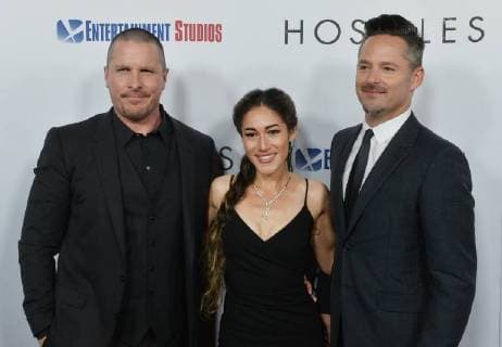 Cast members Christian Bale and Q orianka Kilcher join director Scott Cooper (R) on the red carpet during the premiere of the motion picture western Hostiles at the Academy of Motion Picture Arts & Sciences in Beverly Hills, California on December 14, 2017. Storyline: In 1892, a legendary Army captain reluctantly agrees to escort a Cheyenne chief and his family through dangerous territory.  LAP2017121406 JIMxRUYMEN