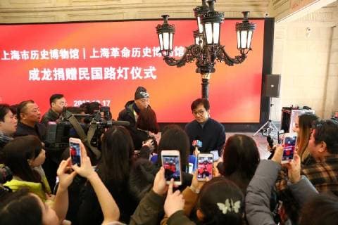 Hong Kong kungfu star Jackie Chan attends a ceremony to mark his donation of an antique street lamp and six replicas to the Shanghai History Museum in Shanghai, China, 17 December 2017. Jackie Chan on Sunday (17 December 2017) donated an antique street lamp and six replicas to the Shanghai History Museum. The 63-year-old film actor posed for pictures with one of the replicas during a ceremony at the museum at 325 Nanjing Road W. The original lamp is undergoing restoration, the museum said. Chan, a keen antiques collector outside his movie career, said he spotted a number of ornate street lamps on sale while filming in the United States many years ago. The Taiwan couple selling them said they were from Shanghai during the Republic of China (1912-1949) period. He bought 19 lamps from the couple at up to US$4,500 each and had them shipped  pbu726482_14