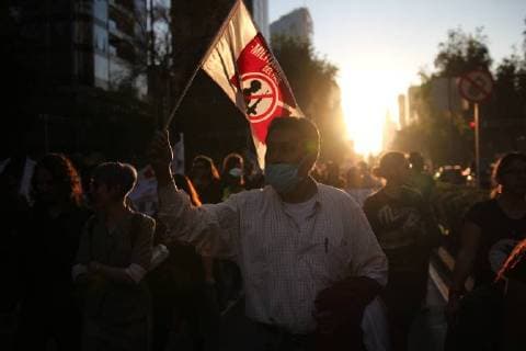 December 21, 2017 - Mexico City, Mexico - A demonstrator holds a banner while marching to protest against the Law of Internal Security, a law that militarizes crime fighting in the country, along Reforma Avenue in Mexico City, Mexico December 20, 2017. Mexico City Mexico  - ZUMAn230 20171221_zaa_n230_001 Copyright: xEmilioxEspejelx