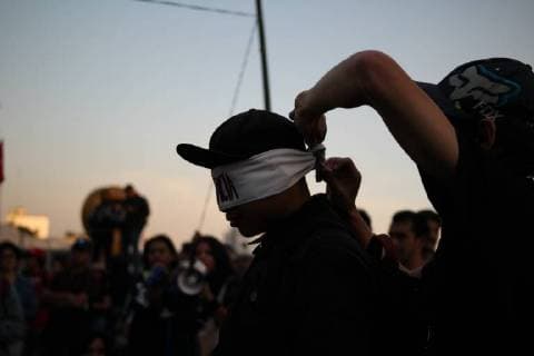 December 21, 2017 - Mexico City, Mexico - Demonstrators break a pioÂ±ata with their eyes covered with a band written in Spanish with the word Indifference while marching to protest against the Law of Internal Security, a law that militarizes crime fighting in the country, along Reforma Avenue in Mexico City, Mexico December 20, 2017. Mexico City Mexico  - ZUMAn230 20171221_zaa_n230_006 Copyright: xEmilioxEspejelx