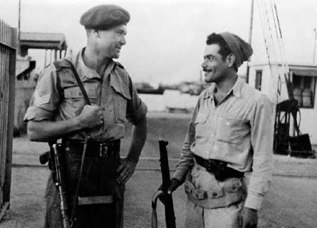 These are the first pictures to be received from Haifa since the Jewish seizure of the town. The only part not occupied being the British held dock area. Photo shows ; A British soldier and a Haganah man guarding one of the entrances to Haifa port. 11 May 1948, Haifa Israel Copyright: Topfoto  !ACHTUNG AUFNAHMEDATUM GESCHÄTZT! UnitedArchives1379552