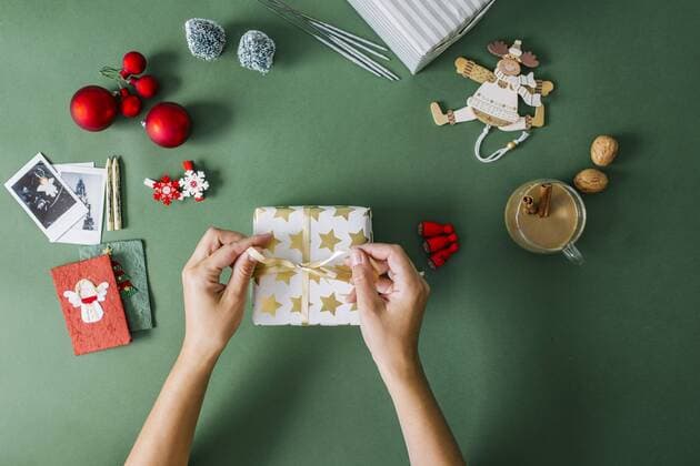 Woman s hands packing Christmas gift model released Symbolfoto property released  MOMF00294