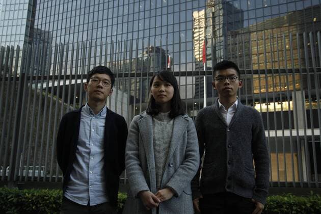 December 27, 2017 - Hong Kong, CHINA - Former student leaders of the 2014 UMBRELLA REVOLUTION and the members of the pro-democratic political party DEMOSISTO, Nathan Law ( L ) Agnes Chow ( C ) Joshua Wong ( R ) pose outside CIVIC SQUARE at HKSAR Central Government Office that has been closed and fenced off from the public for 3 years since the outbreak of UMBRELLA REVOLUTION in 2014. The Square will be opened to public from tomorrow.27-Dec 2017.Hong Kong.ZUMA Hong Kong CHINA - ZUMAl137 20171227_zap_l137_002 Copyright: xLiauxChungxRenx
