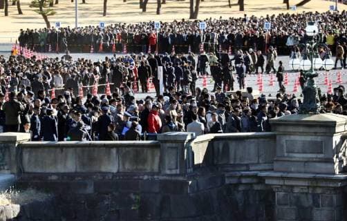 Japan emperor Crowds of people walk across a stone bridge at the Imperial Palace in Tokyo on Jan. 2, 2018, to hear Japanese Emperor Akihito s New Year s greetings. 