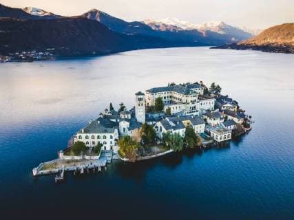 Italy: Aerial of St. Julius island 2018 Aerial pictures of the Isola di San Giulio (St Julius island) at the Lago d Orta (lake Orta) at sunset. FOR EDITORIAL USE ONLY - Alessandro Bosio Pacific Press Agency Orta San Giulio Novara Italy Lago d Orta  AlessandroxBosio