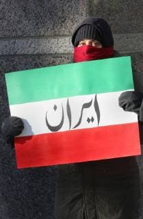 January 6, 2018 - Toronto, Ontario, Canada - Protestor holds a sign mimicking the Iranian flag with the word Iran as hundreds of Canadians take part in a protest against the Islamic Republic of Iran in Toronto, Ontario, Canada, on January 06, 2018. Protestors showed their solidarity with anti-government demonstrators in Iran and their support of a national uprising of the Iranian people. Protesters called for a regime change for social justice and freedom and democracy in Iran. There was a also a call that power in Iran be returned to Reza Pahlavi, the former Crown Prince of Iran and the last heir apparent to the defunct throne of the Imperial State of Iran and the current head of the exiled House of Pahlavi. Toronto Canada  - ZUMAn230 20180106_zaa_n230_1114 Copyright: xCreativexTouchxImagingxLtdx