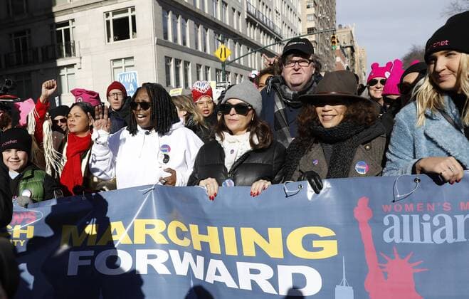 Whoopi Goldberg, Rosie Perez and Michael Moore lead the march down Central Park West at the Women s March rally on January 20, 2018 in New York City. Around the nation hundreds of thousands of Men Women and Children marched on the one-year anniversary of President Donald Trump s swearing-in to protest against his administration policies and to celebrate women s rights around the world.  NYP20180120117 JOHNxANGELILLO