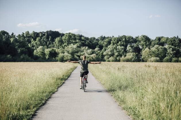 Young man riding a bike, freehand model released Symbolfoto  GUSF00288