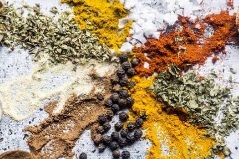 Spices, curry, chilli, cinnamon, curcuma, garlic, parsley, oregano, salt and pepper on wood  SARF03467