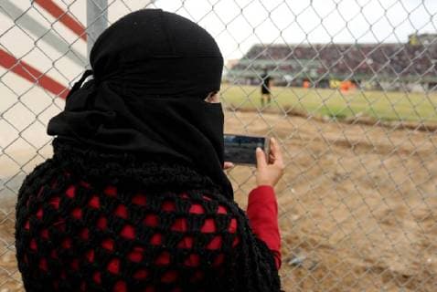 January 28, 2018 - Nuseirat, Gaza Strip, Palestinian Territory - Palestinian women watch the football match between Al-Nuseirat and Al-Jalaa standing outside the fence of the stadium, at Nuseirat refugee camp, in the central of Gaza Strip, on January 28, 2018. Palestinian police allowed women to attending the football match on the first time in Gaza Strip Nuseirat Palestinian Territory - ZUMAap3_ 20180128_zaf_ap3_156 Copyright: xAshrafxAmrax