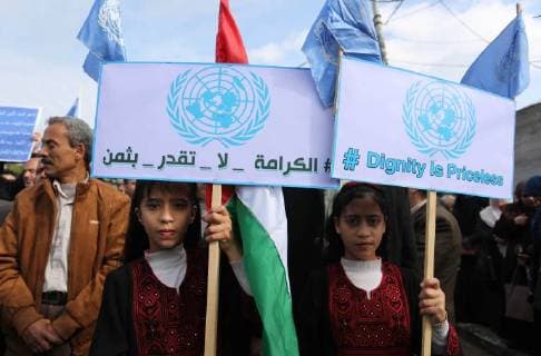 January 29, 2018 - Gaza City, Gaza Strip, Palestinian Territory - Palestinian employee of United Nations Relief and Works Agency (UNRWA) hold a sign during a protest against a U.S. decision to cut aid, in Gaza City January 29, 2018 Gaza City Palestinian Territory - ZUMAap3_ 20180129_zaf_ap3_140 Copyright: xAshrafxAmrax