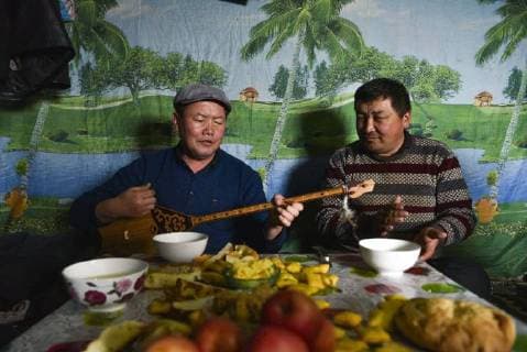 (180203) -- ILI, Feb. 3, 2018 -- A doctor plays dombra in a herder s home after inspection in Akyaz Valley, Zhaosu County, northwest China s Xinjiang Uygur Autonomous Region, Jan. 16, 2018. About 130 kilometers from the nearest town, Akyaz Valley is an important winter grazing place for herders in Zhaosu County, Xinjiang. Despite an altitude of 2,000 meters, the Akyaz Valley has a warmer climate than surrounding areas and abundant grass and water. It is sometimes referred to as the valley of life. For centuries, herding has been an ancestral tradition for nomadic Kazakhs in Zhaosu. Migration begins in October, and more than 10,000 people drive 400,000 cattle and sheep to their winter homes, not leaving until May the next year. ) (wyo)(zt) CHINA-XINJIANG-AKYAZ VALLEY-WINTER GRAZING (CN) HuxHuhu 