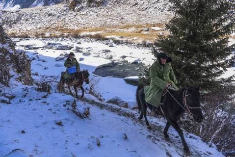 (180203) -- ILI, Feb. 3, 2018 -- Gyens (R), head of the local hospital, and his colleague are on the way to a patient s home in Akyaz Valley, Zhaosu County, northwest China s Xinjiang Uygur Autonomous Region, Jan. 17, 2018. About 130 kilometers from the nearest town, Akyaz Valley is an important winter grazing place for herders in Zhaosu County, Xinjiang. Despite an altitude of 2,000 meters, the Akyaz Valley has a warmer climate than surrounding areas and abundant grass and water. It is sometimes referred to as the valley of life. For centuries, herding has been an ancestral tradition for nomadic Kazakhs in Zhaosu. Migration begins in October, and more than 10,000 people drive 400,000 cattle and sheep to their winter homes, not leaving until May the next year. ) (wyo)(zt) CHINA-XINJIANG-AKYAZ VALLEY-WINTER GRAZING (CN) HuxHuhu 