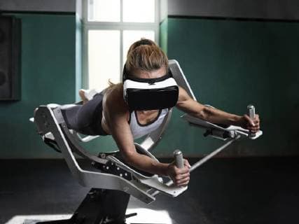 IMAGO Creative: Sport Start-Up Woman wearing VR glasses using futuristic fitness machine model released Symbolfoto property released  CVF00014