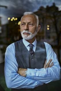Elegant senior man looking out of window model released Symbolfoto property released  ZEDF01115