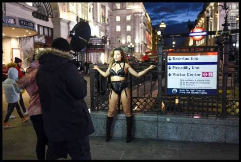 . 26 02 2018. London, United Kingdom. Beast from the East - London Weather. A model wearing only lingerie braves the freezing weather to pose for a film crew in London s Piccadilly Circus.  xPetexMaclainex xi-Imagesx IIM-17072-0009