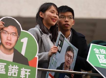 March 11, 2018 - Hong Kong, CHINA - Disqualified candidate for 2018 LEGICO By-Election, Agnes Chow of DEMOSISTO ( L ) and former student leader and prominent political activist, Joshua Wong ( R ) turned up to support Candidate No.1 Au Nok-hin of Democratic Party on the voting day in the last-run campaign. Mar-11, 2018. Hong Kong.ZUMA Hong Kong CHINA - ZUMAl137 20180311_zap_l137_017 Copyright: xLiauxChungxRenx