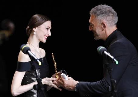 MOSCOW, RUSSIA â€“ MARCH 11, 2018: French actor Vincent Cassel (R) gives Bolshoi Ballet principal dancer Svetlana Zakharova the Best Ballet trophy for her Amore project at a ceremony to present BraVo international professional music awards at the Bolshoi Theatre. Artyom Geodakyan TASS  TS07740A