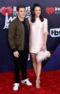 (L-R) Actors Adam DeVine and Chloe Bridges arrive for the iHeartRadio Music Awards at The Forum in Inglewood, California on March 11, 2018. Turner s TBS, TNT, and truTV channels broadcasted the ceremony live from The Forum.  LAP20180311128 JIMxRUYMEN