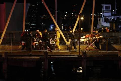 (180312) -- NEW YORK, March 12, 2018 -- A helicopter crash victim is transferred by Fire Department officers at 34th Street Ferry Terminal in Manhattan of New York City, the United States, March 11, 2018. A helicopter crashed in New York City s East River on Sunday, killing at least two people, according to police. )(srb) U.S.-NEW YORK-HELICOPTER CRASH LixMuzi 