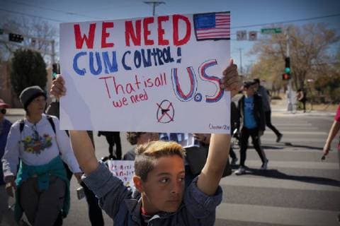 March 24, 2018 - Albuquerque, New Mexico, U.S - Twelve year old CHRISTIAN TAFOYA (CQ), center, of Rio Rancho, New Mexico, holds a sign and marches along Lomas Ave. with thousands of people in the March For Our Lives rally in Albuquerque, New Mexico Saturday March 24, 2018. Albuquerque U.S. - ZUMAv88_ 20180324_zap_v88_008 Copyright: xPatxVasquez-Cunninghamx