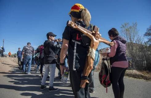 March 30, 2018 - U.S. - Anne Probst, from Santa Fe, waits in line to enter the Santuario de Chimayo with a crucifix made by her father Manny Gurule who was unable to come this year. Thousands of people were making their Good Friday pilgrimage to the Northern New Mexico Church, Friday March 30, 2018. U.S. - ZUMAab1_ 20180330_zaf_ab1_009 Copyright: xEddiexMoorex