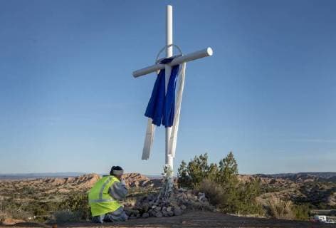 March 30, 2018 - U.S. - Cleo Gonzales, from near Las Vegas, prays before a cross on her way to the Santuario de Chimayo. Thousands of people were making their Good Friday pilgrimage to the Northern New Mexico Church, Friday March 30, 2018. U.S. - ZUMAab1_ 20180330_zaf_ab1_012 Copyright: xEddiexMoorex