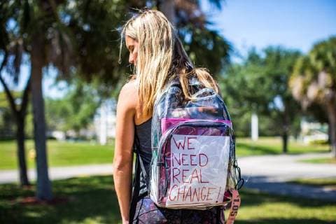 April 6, 2018 - Coral Springs, FL, USA - Madison Leal, a Marjory Stoneman Douglas High School junior, poses with her newly issued mandatory clear backpack near the school on 4 6 2018. She decorated her bag in protest with pins and a message reads We Need Real Change. Many students are openly expressing how upset they are about being issued mandatory clear backbacks by the Broward County School Board upon their return from Spring Break on 4 2 2018. For many students, they had just returned from March For Our Lives D.C and Parkland. They feel that this isn t what they marched for. Coral Springs U.S.  - ZUMAr152 20180406_zaa_r152_110 Copyright: xIanxWitlenx xRmvx