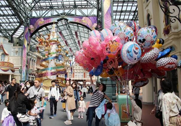 April 10, 2018, Urayasu, Japan - A guest buys a Disney character balloon at the Tokyo Disneyland in Urayasu, suburban Tokyo durng a press preview for the park s 35th anniversary event on Tuesday, April 10, 2018. Tokyo Disneyland will celebrate its 35th anniversary on April 15 and the new attractions of the Happiest Celebration will be held for a year.  (75851025)