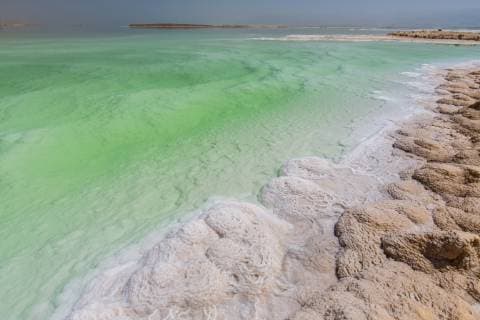 Crystallized salt cover the beach of Dead Sea in Israel.  BEW1D2162ED