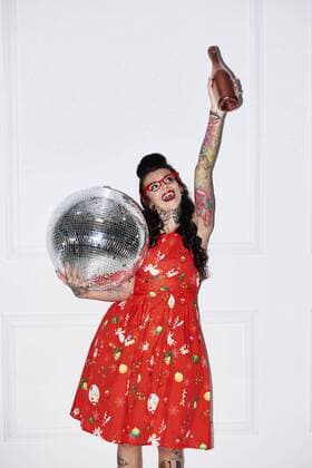 Portrait of tattooed woman with champagne bottle and disco ball model released Symbolfoto  ABIF00136