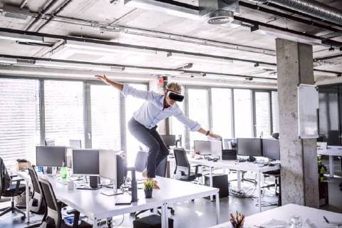 Barefoot mature businessman on desk in office wearing VR glasses model released Symbolfoto property released  HAPF02708