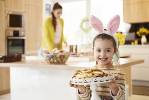Portrait of smiling girl with bunny ears serving cookies model released Symbolfoto property released  ABIF00155