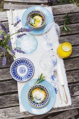 Garden table laid with colorful plates and bowls property released  GWF05466