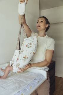 Midwife using baby scales to weigh newborn model released Symbolfoto property released  MFF04405