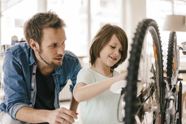 Father and son repairing bicycle together at home model released Symbolfoto property released  KNSF03587