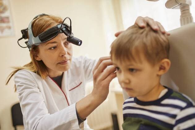 ENT physician examining ear of a boy model released Symbolfoto property released  ZEDF01229