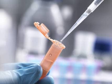Scientist pipetting a sample into a eppendorf tube model released Symbolfoto property released  ABRF00130