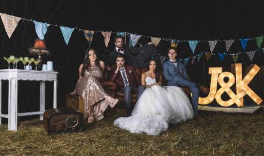 Portrait of wedding couple with friends on sofa on a night field party model released Symbolfoto property released  DAPF00931