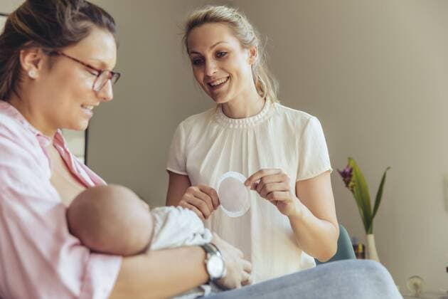 Midwife holding a disposable nursing pad for breastfeeding mother model released Symbolfoto property released  MFF04407