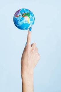 Close-up of globe on woman s finger model released Symbolfoto  SRYF00771
